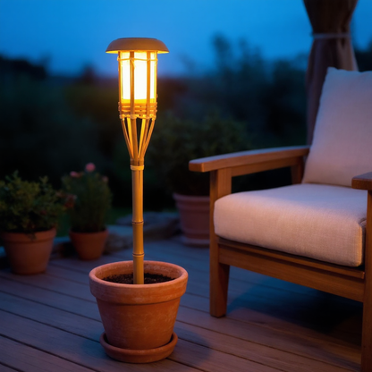 Solar bamboo flame torch light beside a wood deck at blue hour