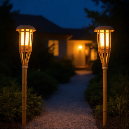 Solar bamboo flame torch lights lining a gravel garden path at night