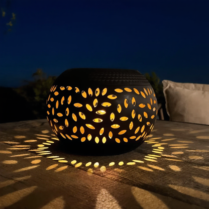 LumoPattern solar garden lantern glowing on a stone terrace at night